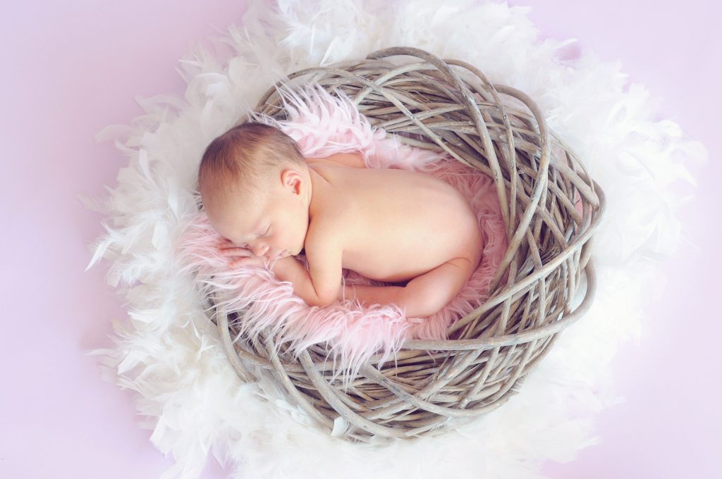 A sleeping baby in wicker basket